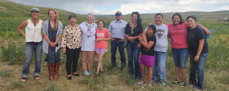 Eleven people standing in a field